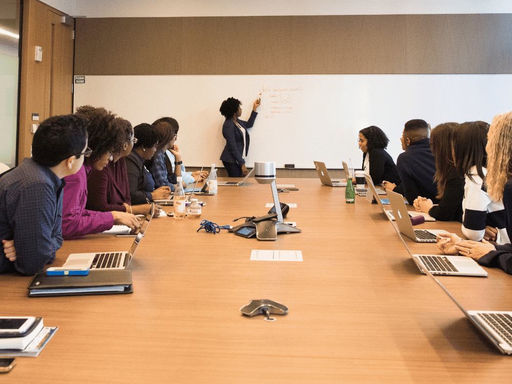 Diverse business professionals focused on a presentation in a meeting.