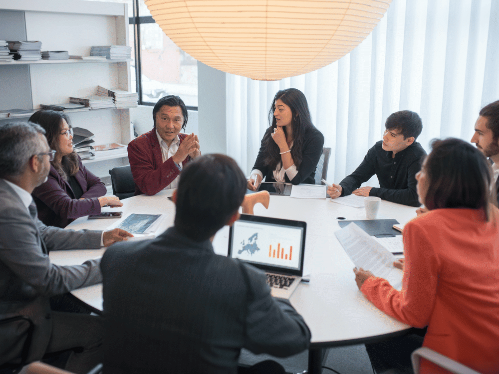 Diverse business team engaged in a strategic planning session around a table.