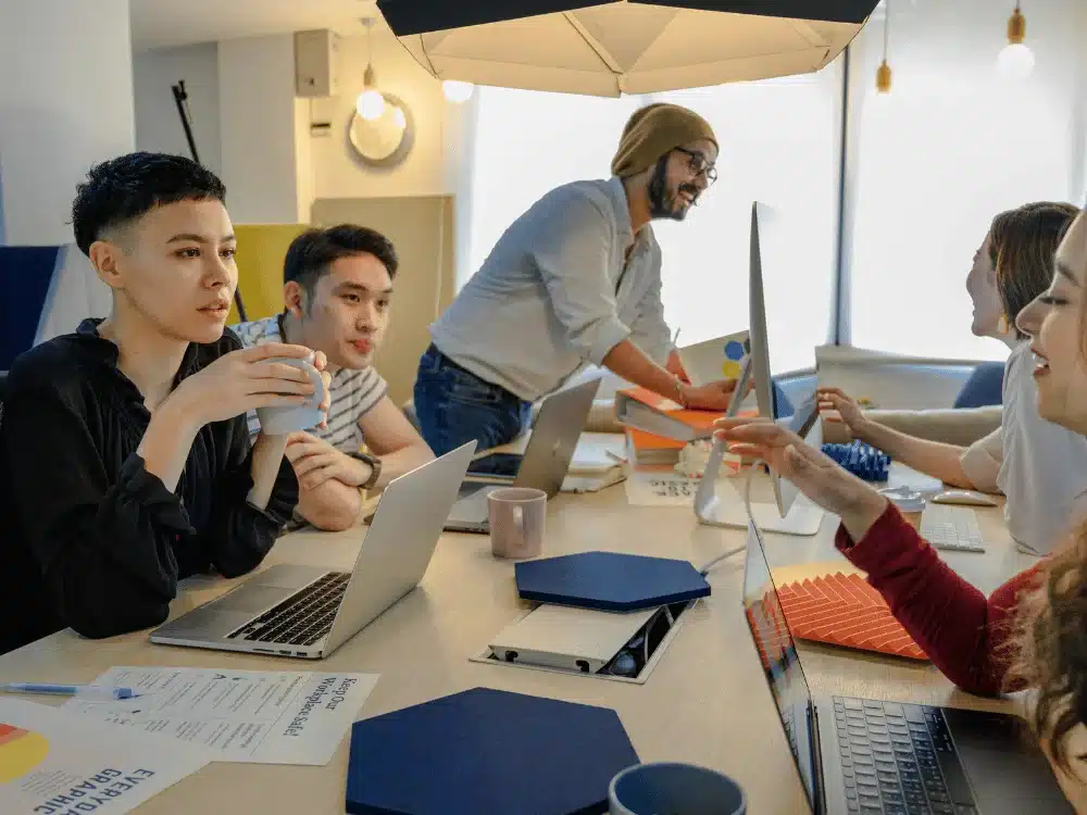 Group of diverse professionals working together at a meeting table.