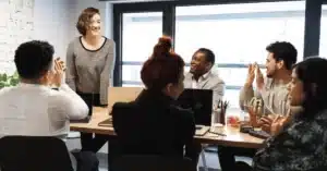 Group of professionals in a meeting with someone presenting.