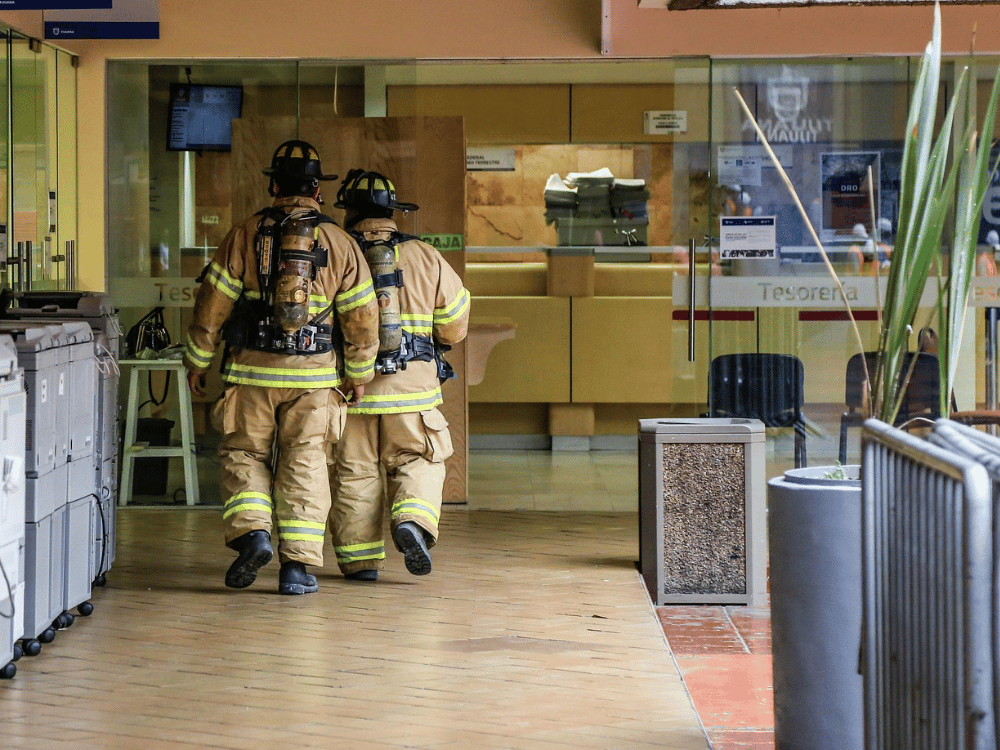 Two persons in firefighter uniform in the lobby.