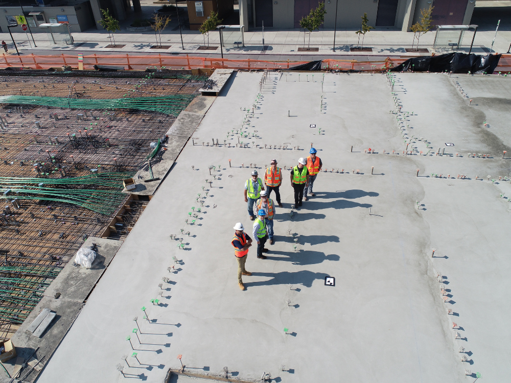 Construction team inspecting the site with steel rebar before concrete pouring.