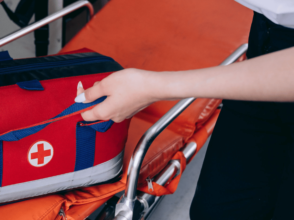 Detailed view of an EMT's hand on an emergency kit.