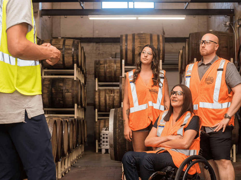 Diverse group of employees with one in a wheelchair at a warehouse.