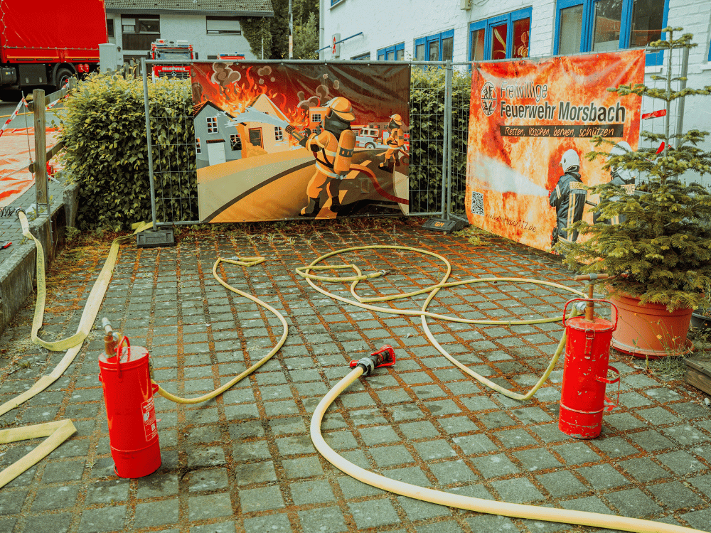 Firefighting equipment and hoses laid out at a fire station training setup.