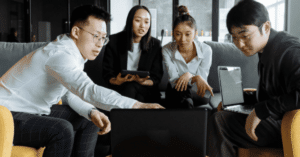 Diverse business group collaborating on a project with a computer.