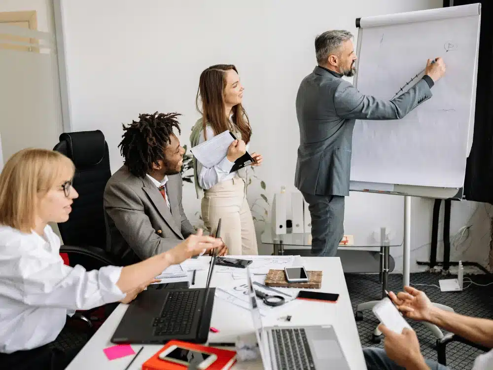 Enthusiastic business team during a whiteboard presentation.