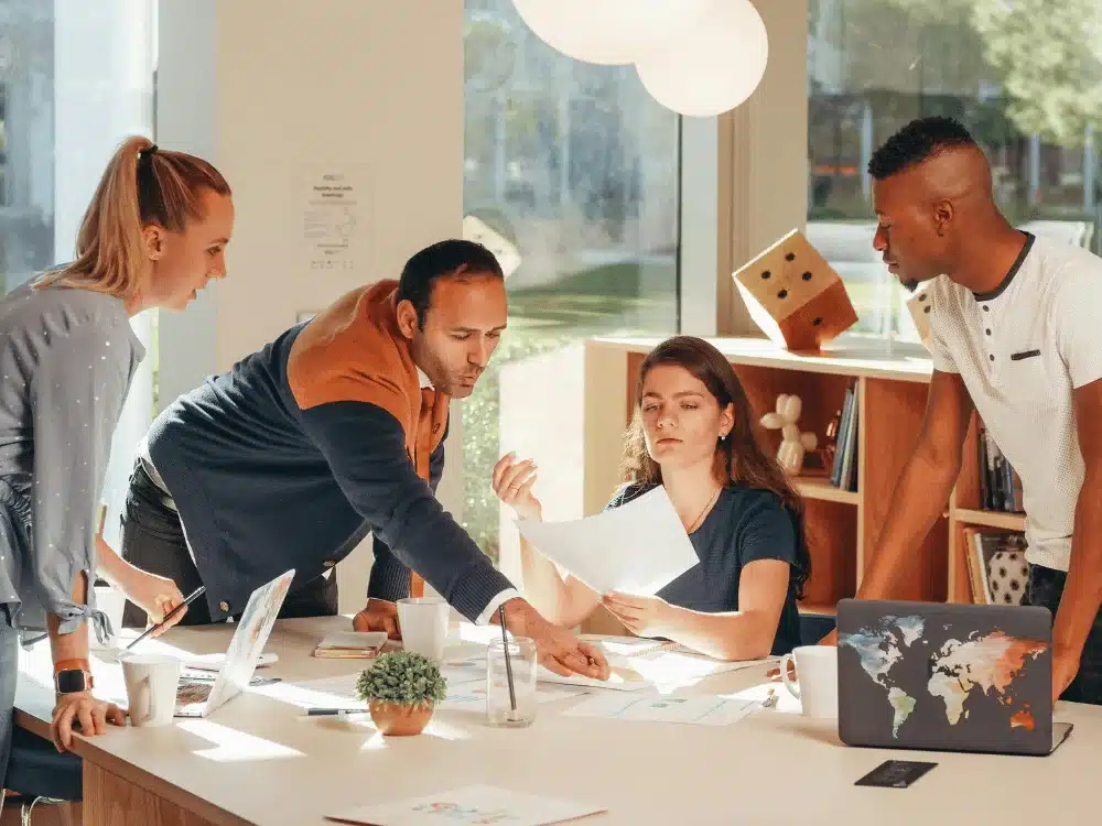 Diverse team working together on a project in a modern office.