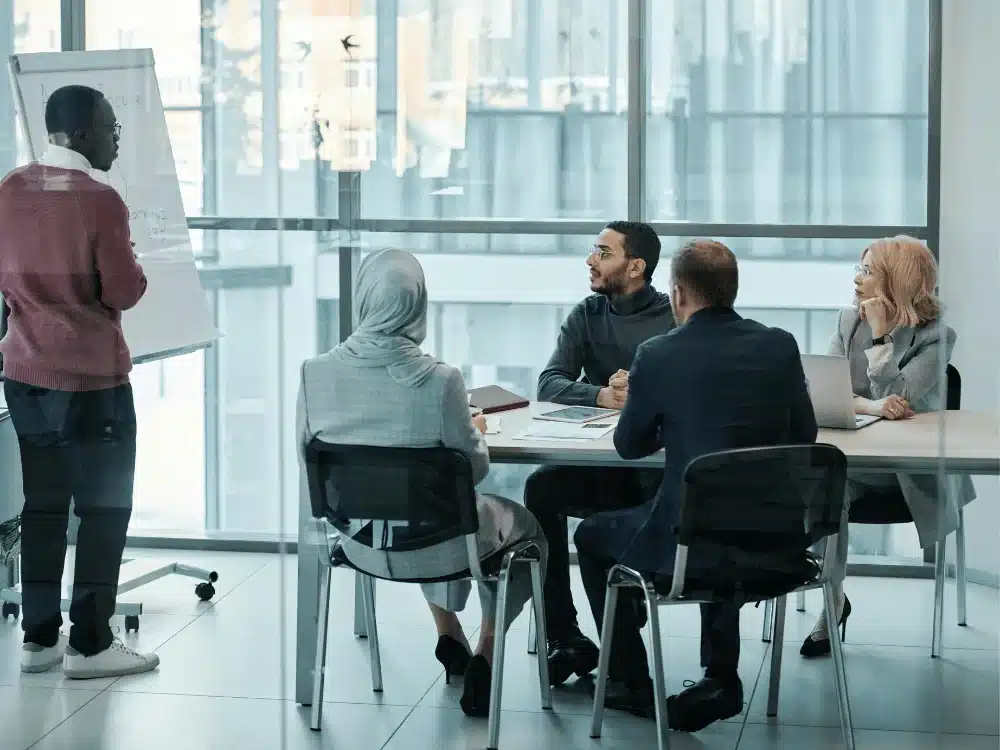 Group of professionals having a discussion in a contemporary office setting.
