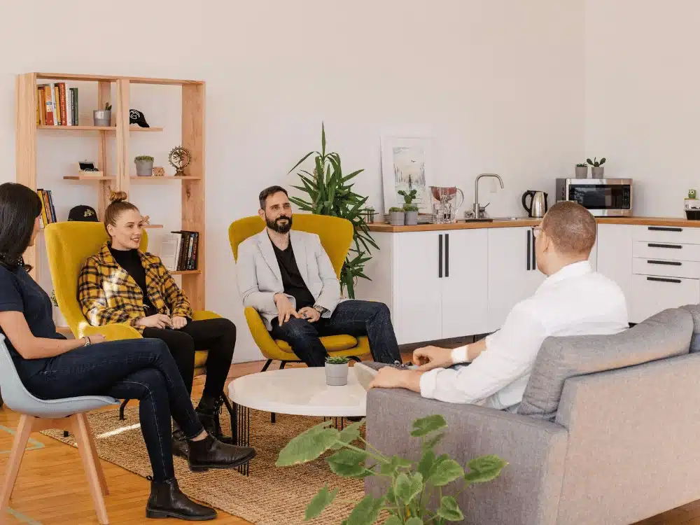 Team having informal meeting in cozy office lounge.