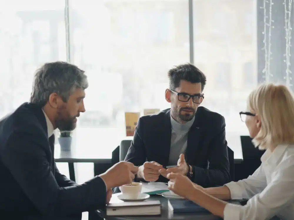 Business professionals having serious discussion in café meeting.